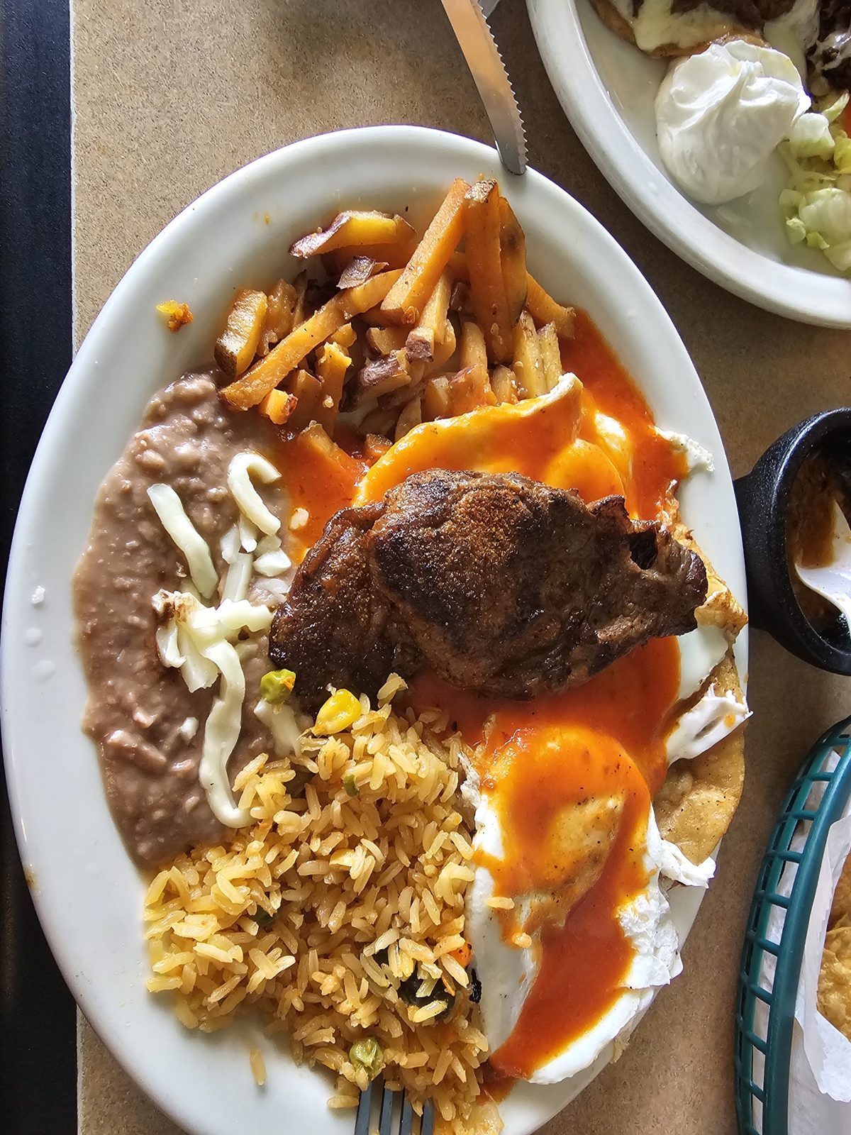 Chilaquiles with eggs, beans and steak